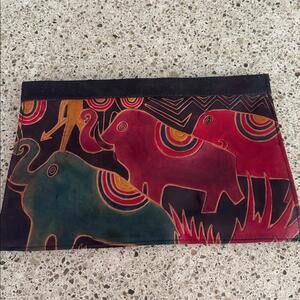 Leather hand crafted clutch purse with colorful elephants.